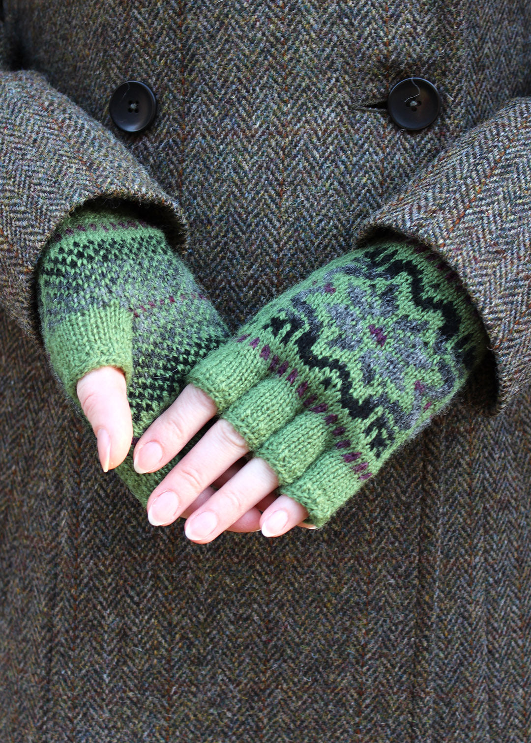 Hand knitted gloves in moss green with Fair Isle pattern.