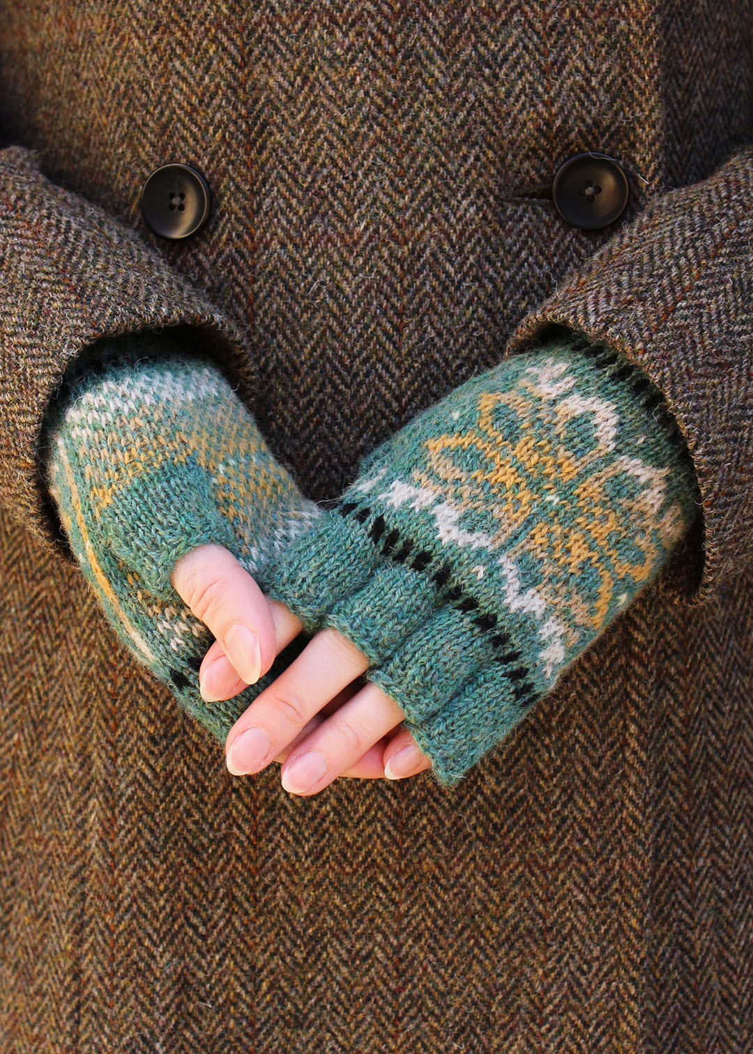 Hand knitted gloves in green marl with Fair Isle pattern.