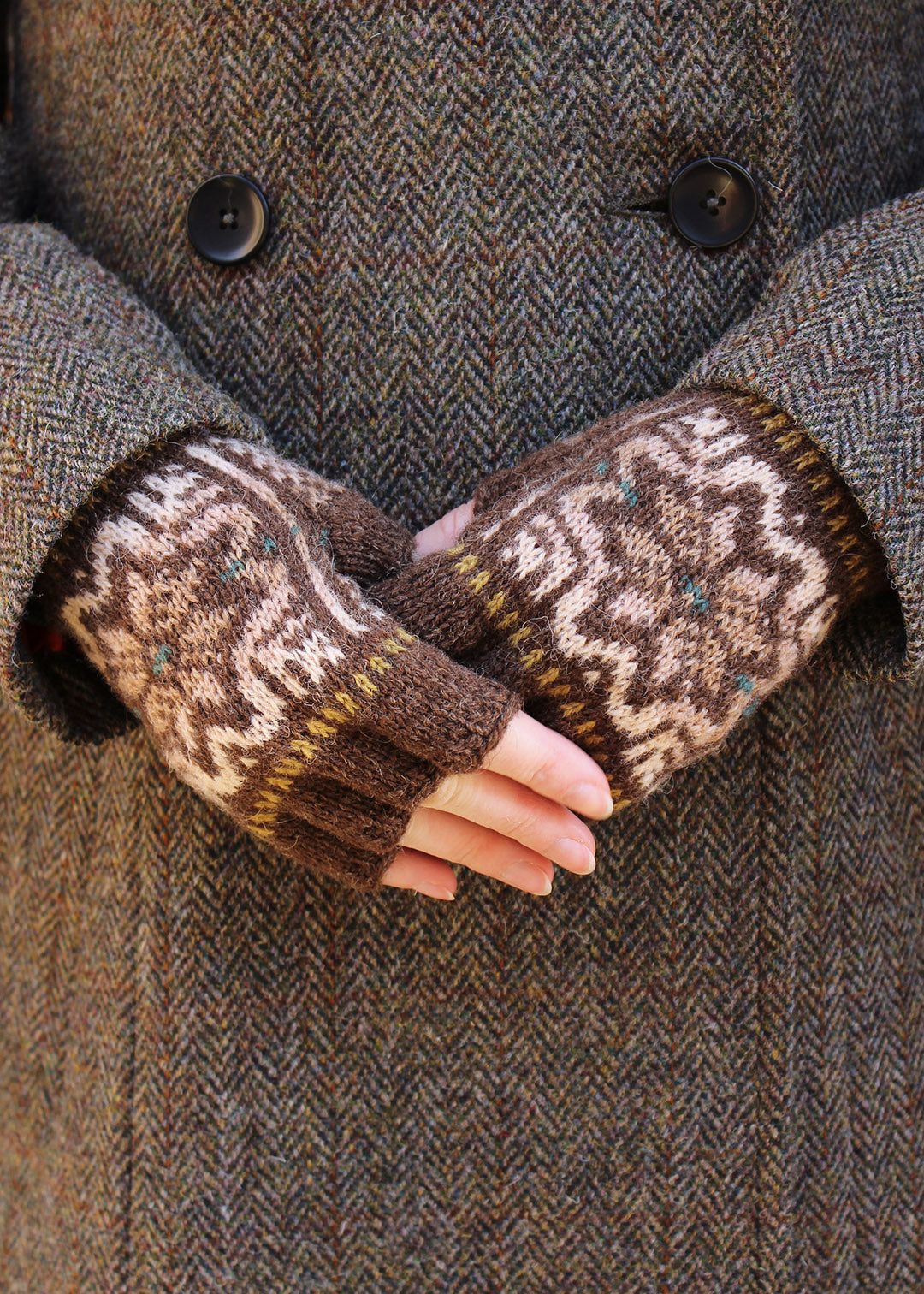 Hand knitted fingerless gloves in brown with Fair Isle pattern.