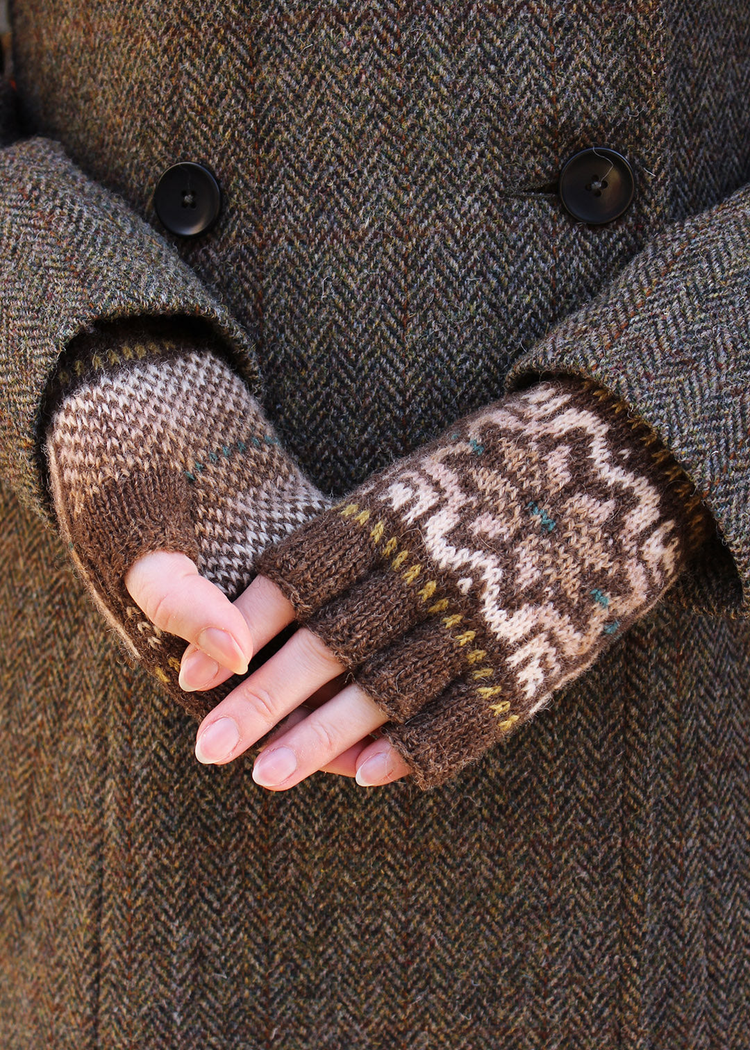 Hand knitted fingerless gloves in brown with Fair Isle pattern.