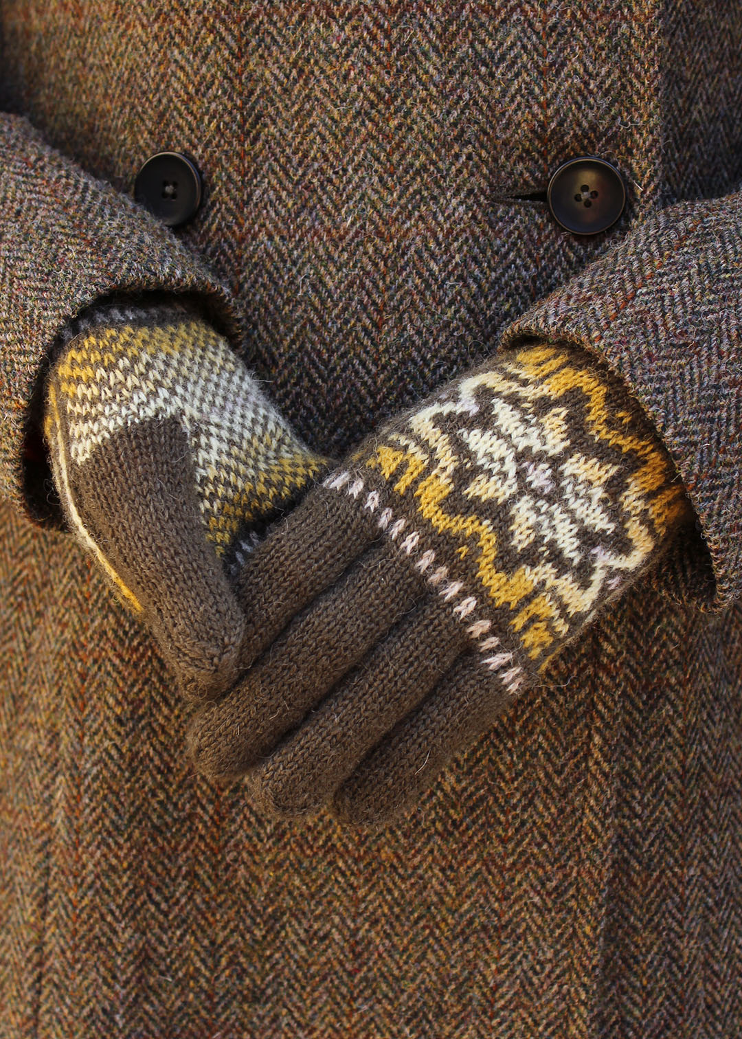 Hand knitted gloves in khaki green with Fair Isle pattern.