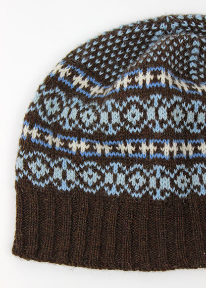 Hand knitted Fair Isle beanie hat in brown with contrasting details.