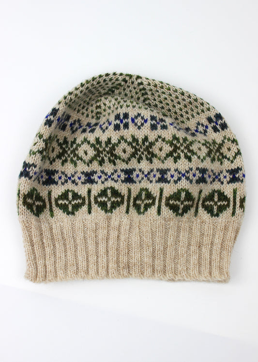 Hand knitted Fair Isle beanie hat in shades of cream with contrasting details.