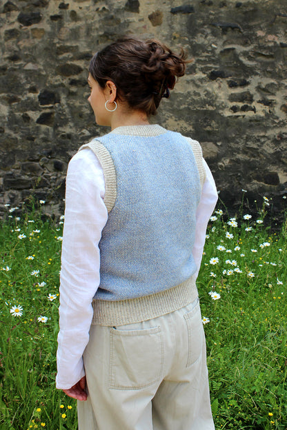 Shetland knitted tank top in pale blue and natural pale grey wool with round neck. Back view.