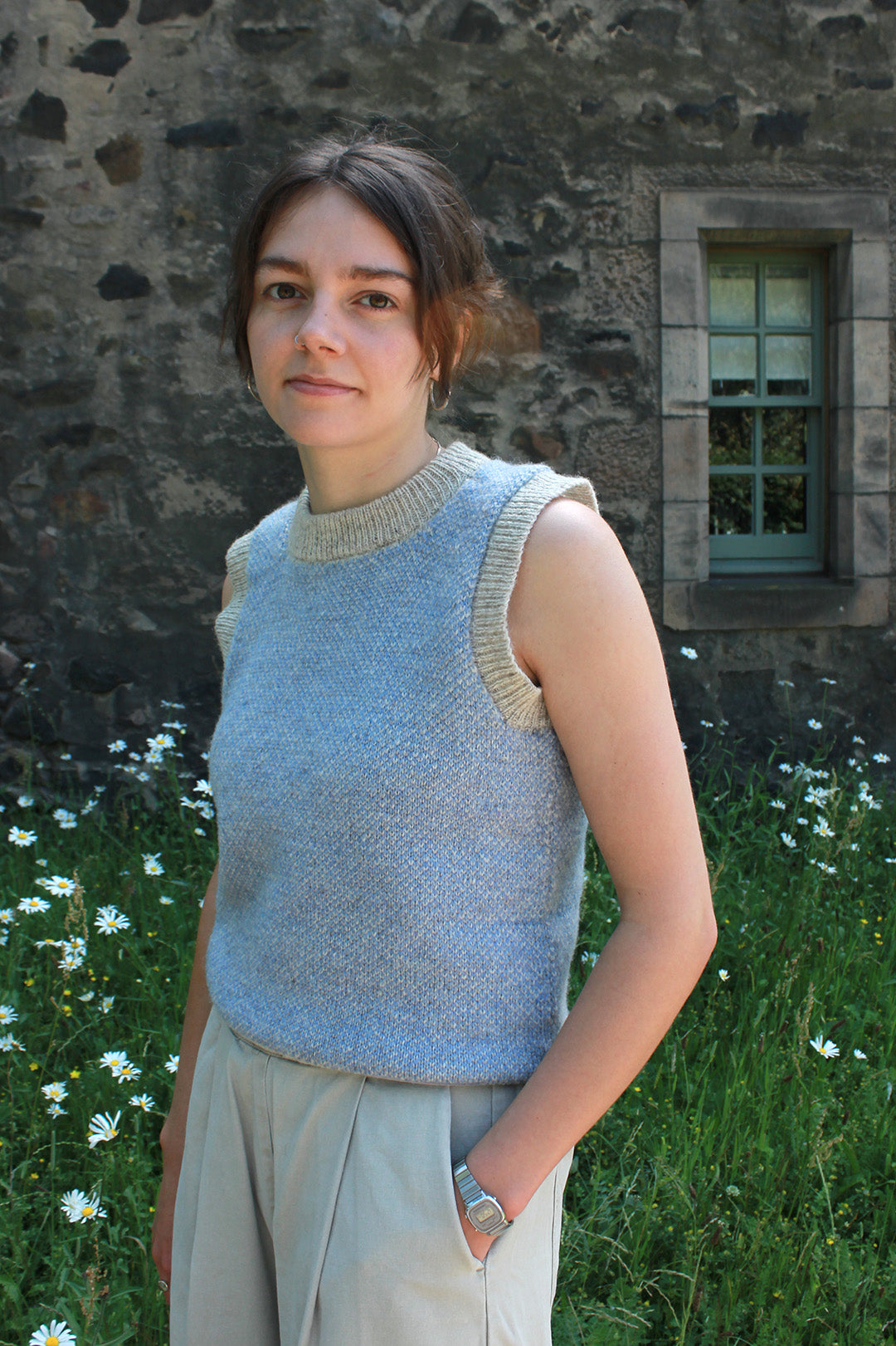 Shetland knitted tank top in pale blue and natural pale grey wool with round neck.