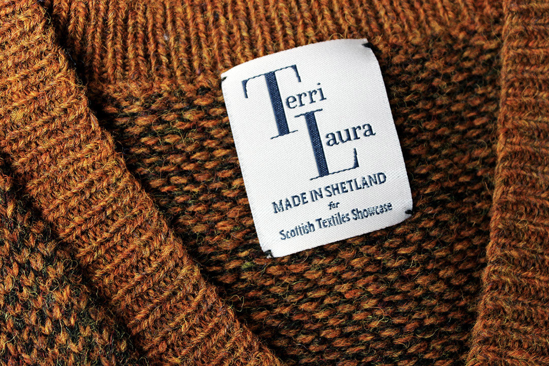 Shetland knitted tank top in burnt umber, with a v-neck. Shown close up with Scottish Textiles Showcase and Terri Laura label.