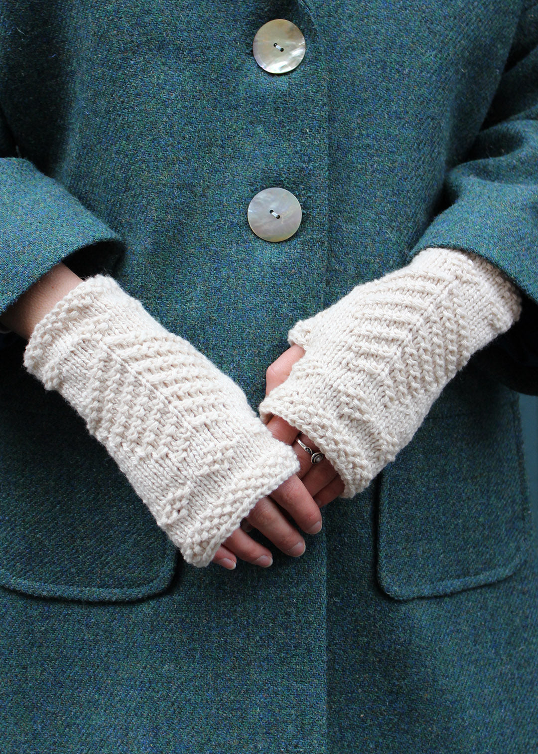 Hand knitted fingerless wristwarmers made in soft crowdie cream lambswool, with intricate tree of life motif.&nbsp;