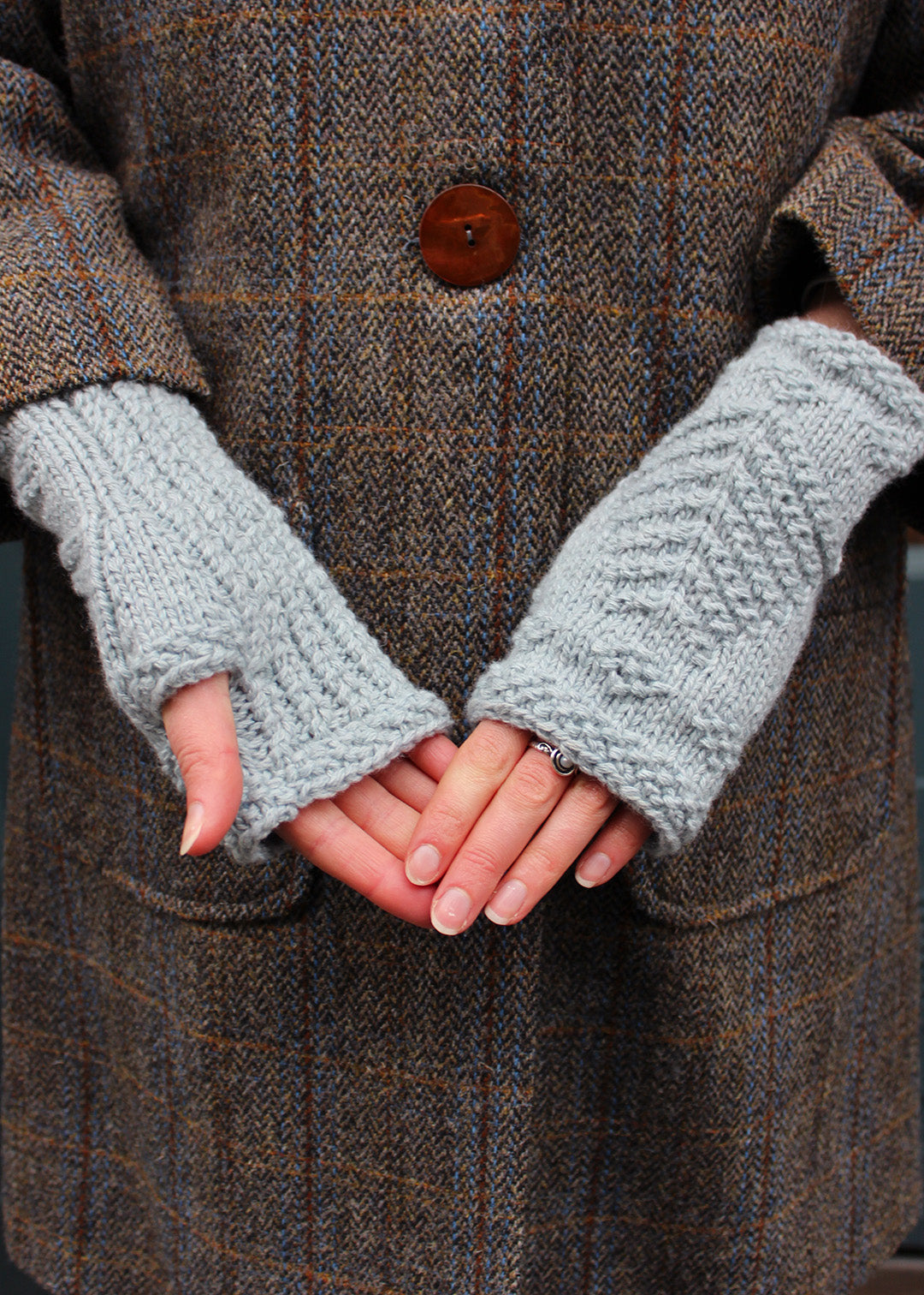 Hand knitted fingerless wristwarmers made in soft haar blue lambswool, with intricate tree of life motif.&nbsp;