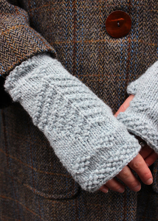 Hand knitted fingerless wristwarmers made in soft haar blue lambswool, with intricate tree of life motif.&nbsp;