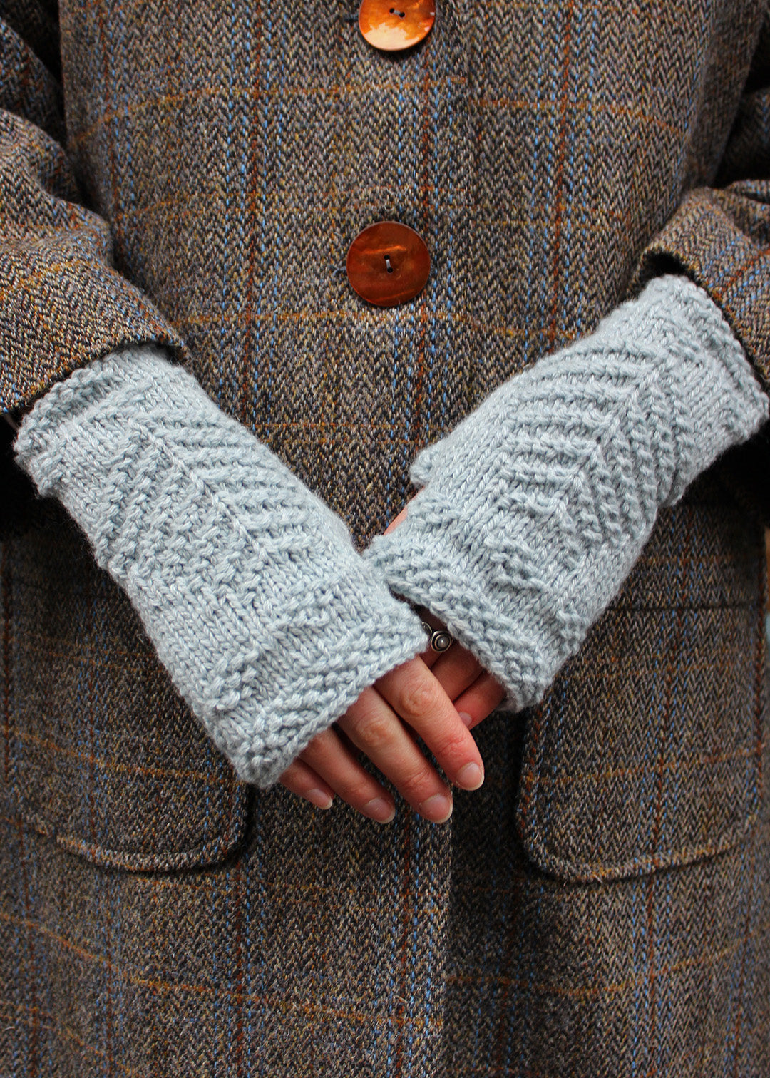 Hand knitted fingerless wristwarmers made in soft haar blue lambswool, with intricate tree of life motif.&nbsp;