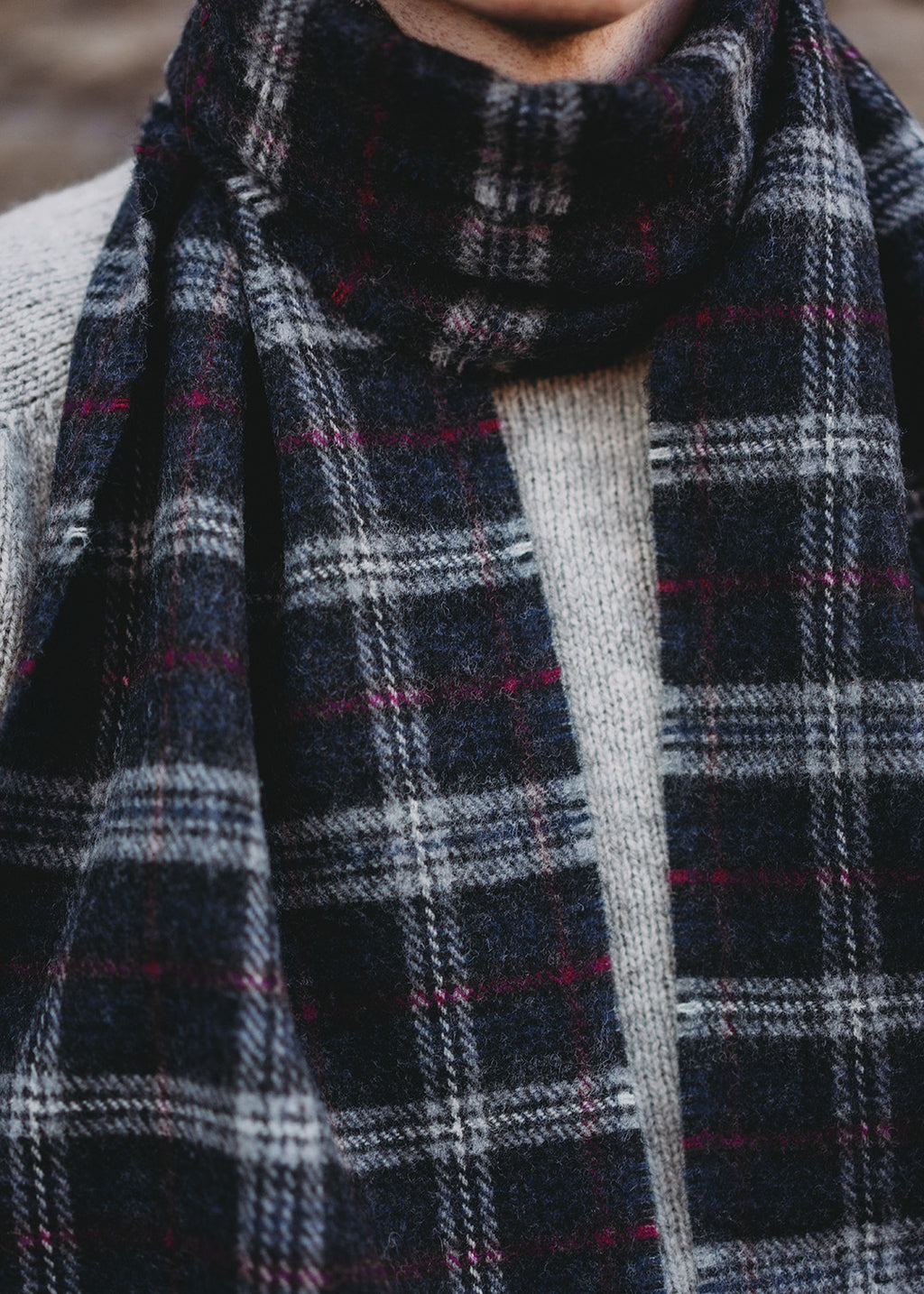 The Warrior Poet scarf is woven in soft, brushed lambswool with a classic check in colours inspired by the Scottish landscape.