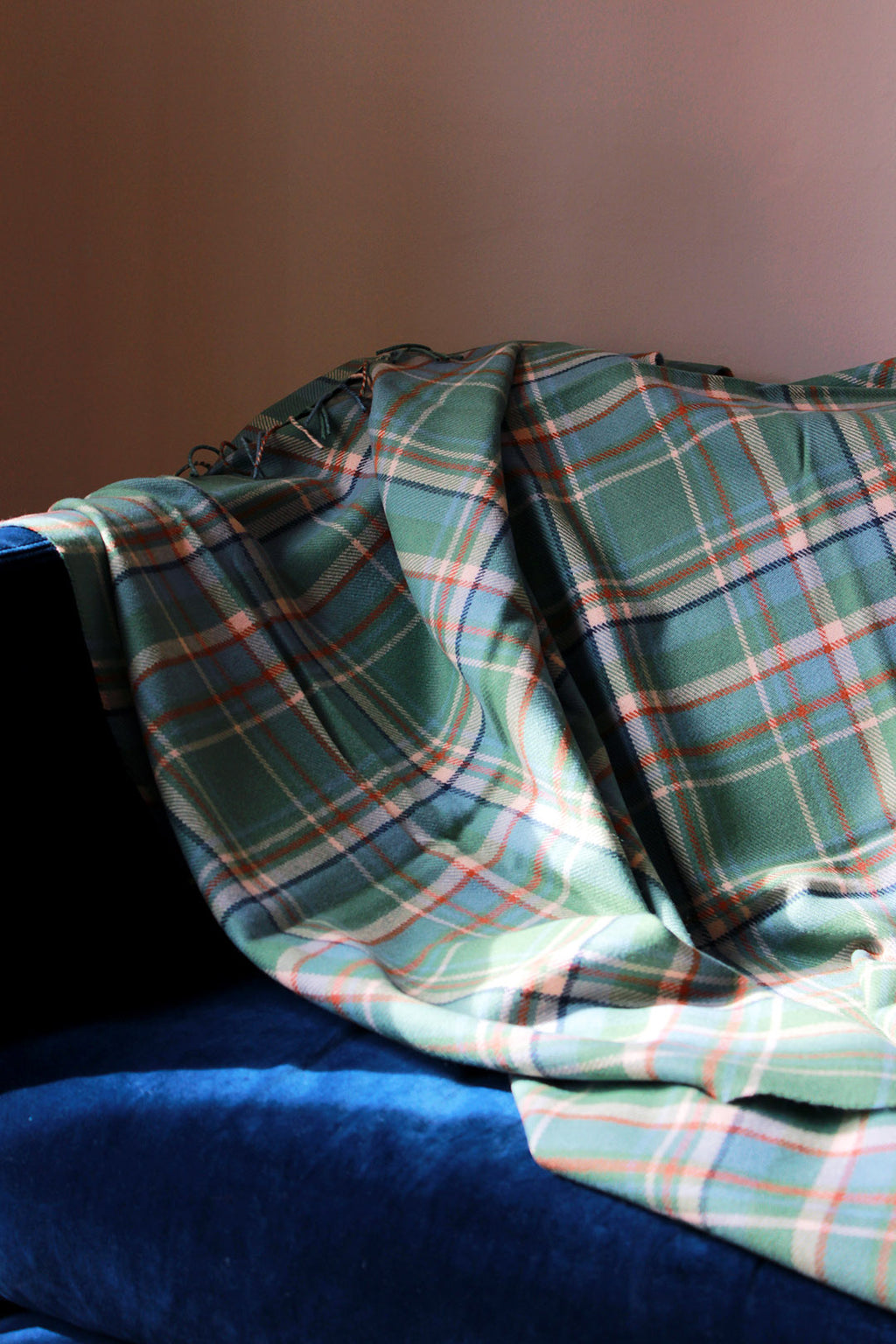 Limited edition Highlands at Dawn lambswool blanket features an original plaid design by Araminta Campbell