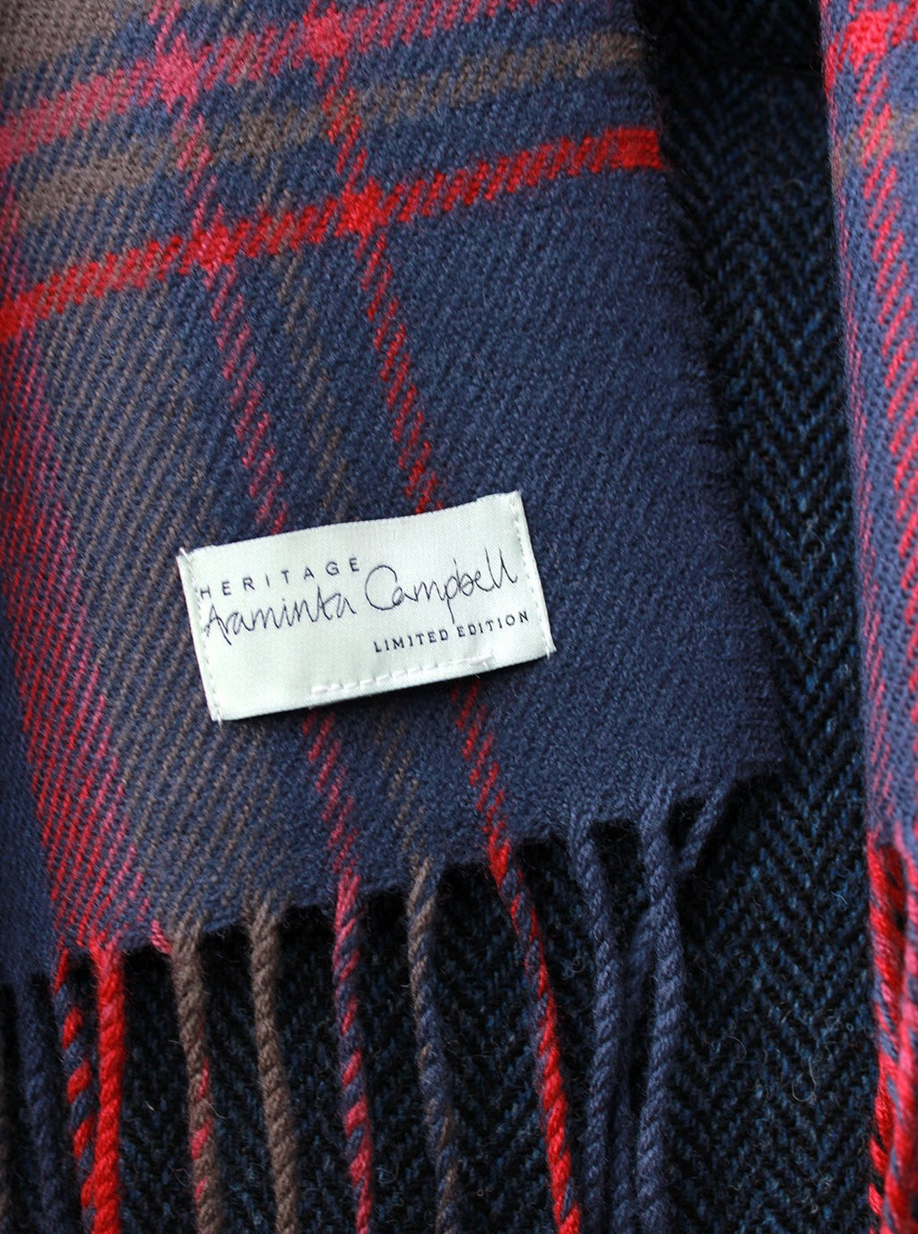 Araminta Campebell Highlands at Dusk woven lambswool serape with tassels. Woven with muted dusky blue, grey and sunset red. Scottish Textiles Showcase.