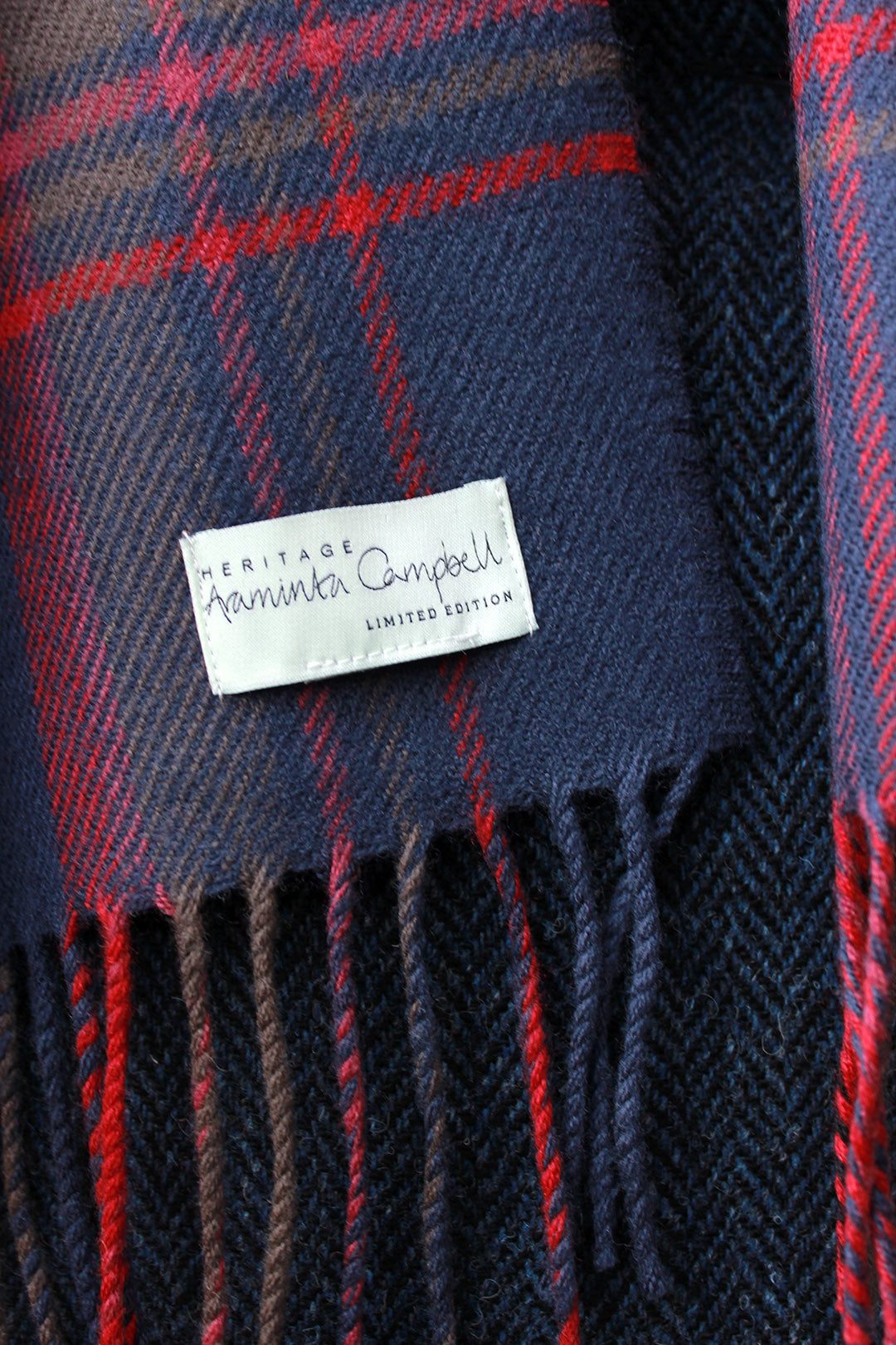 Araminta Campebell Highlands at Dusk woven lambswool scarf with tassels. Woven with muted dusky blue, grey and sunset red. Scottish Textiles Showcase.