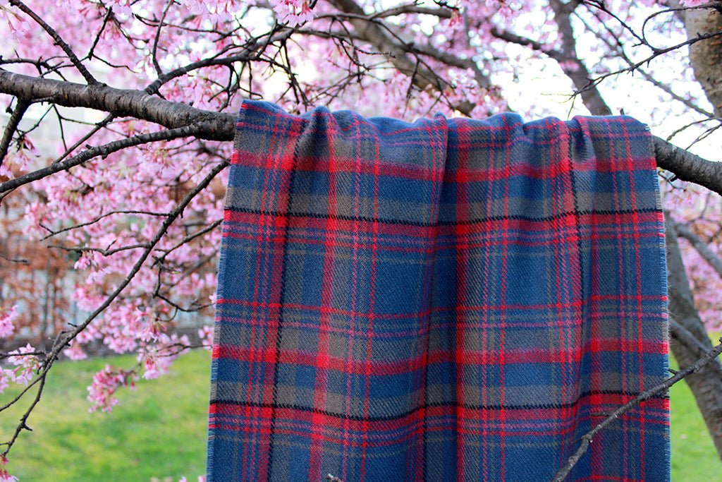 Araminta Campebell Highlands at Dusk woven lambswool shawl with tassels. Woven with muted dusky blue, grey and sunset red. Scottish Textiles Showcase.