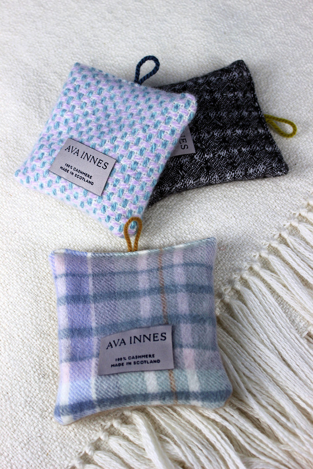 Sustainable hanging lavender bags in a range of pure cashmere check pattern designs. Colours include soft blue, lilac, purple, pink and grey. Scottish Textiles Showcase.