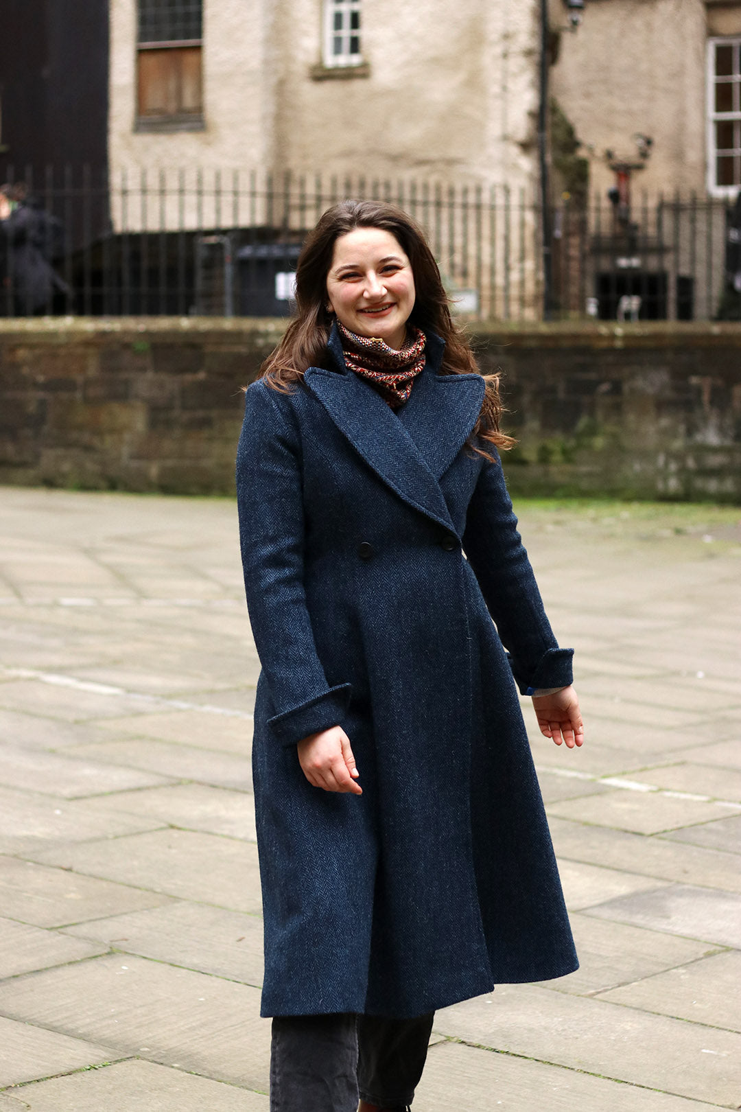 Navy blue and black herringbone Harris Tweed ladies coat shown on model.