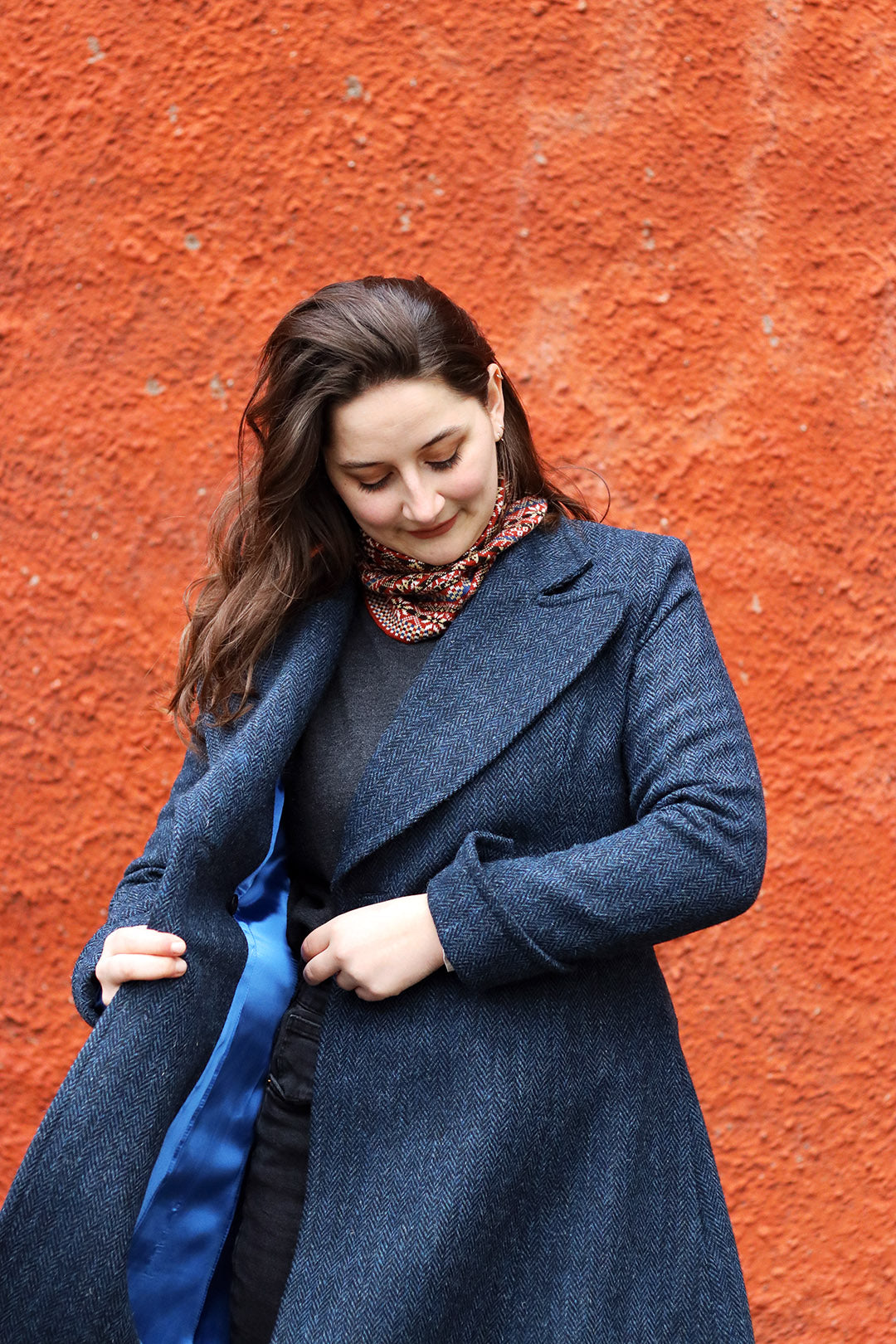 Navy blue and black herringbone Harris Tweed ladies coat shown on model.