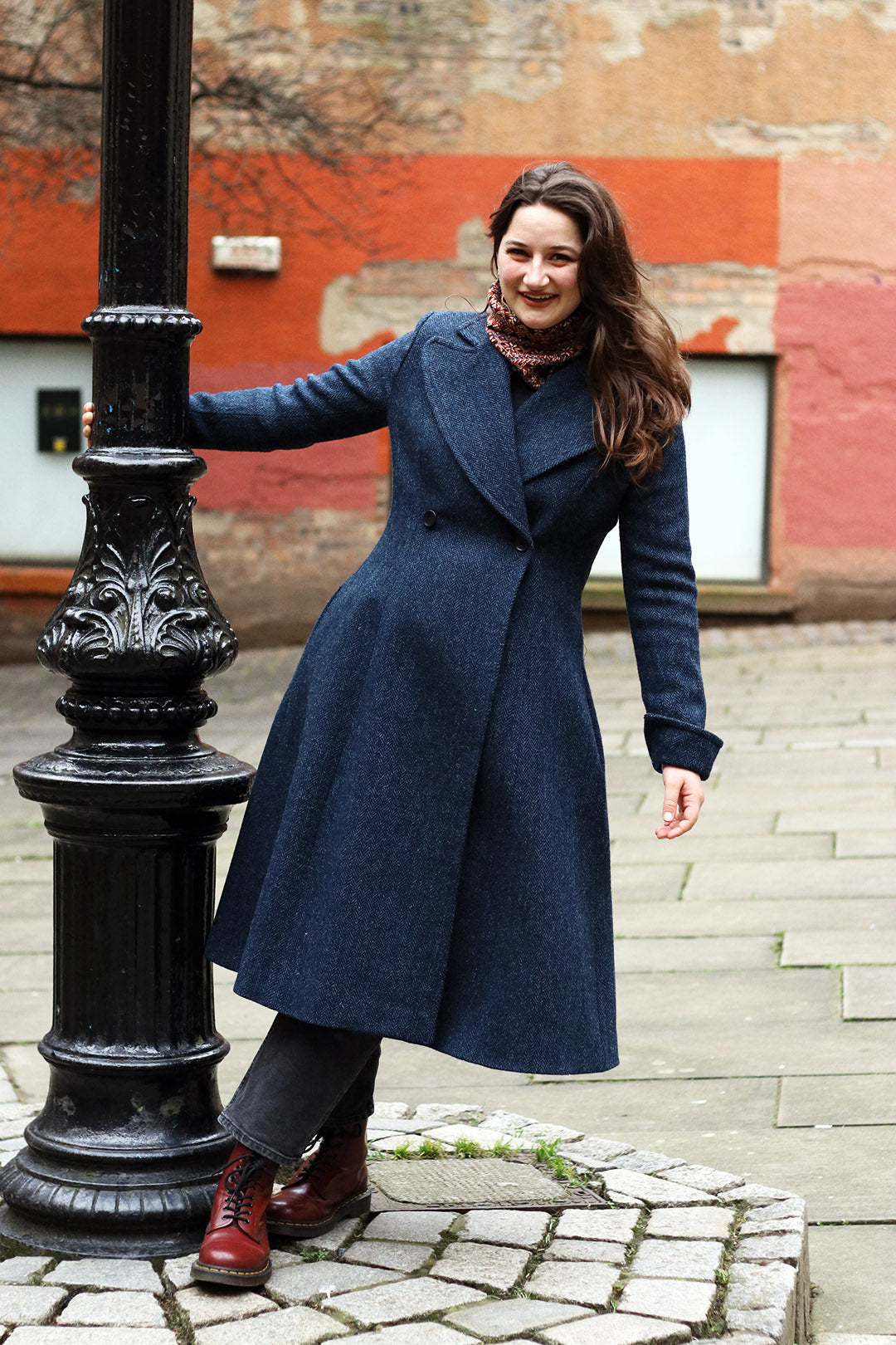 Navy blue and black herringbone Harris Tweed ladies coat shown on model.