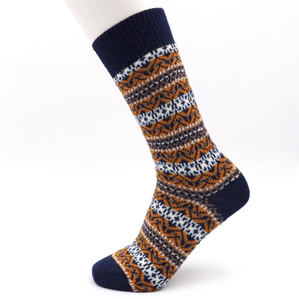 A wool sock in a navy, yellow, and white fairisle design.