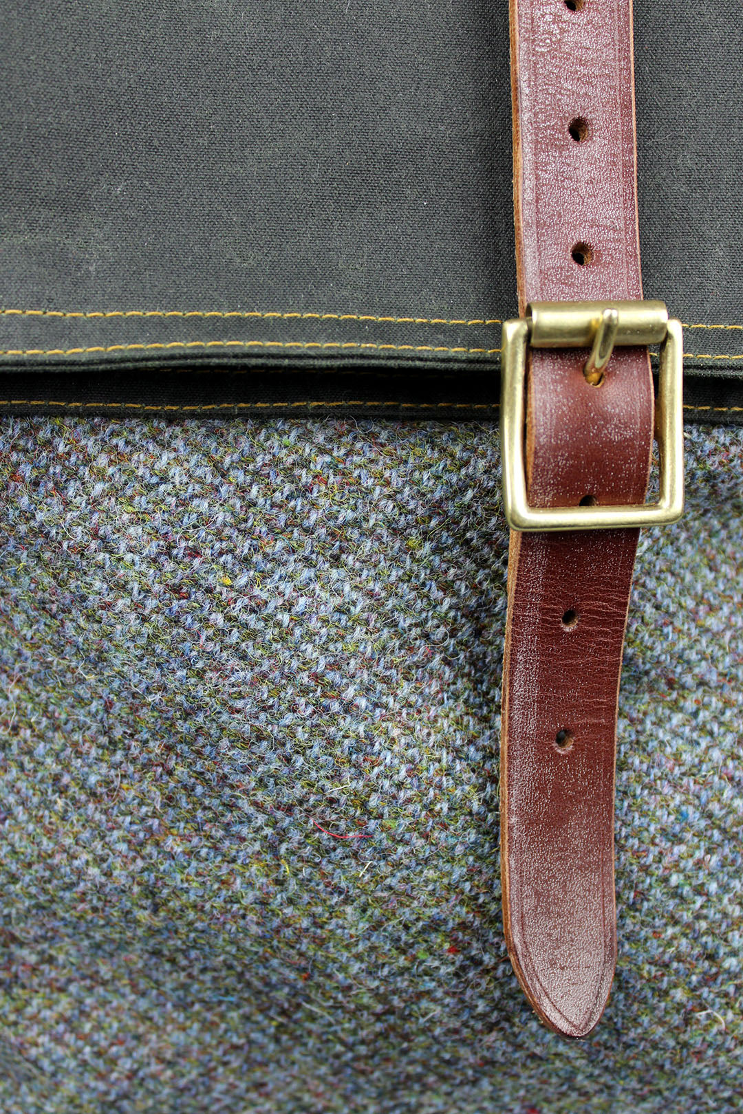 Cairn roll-top bags are a great combination of two Scottish cloths, waxed cotton canvas and Harris Tweed, finished with oak tanned leather.