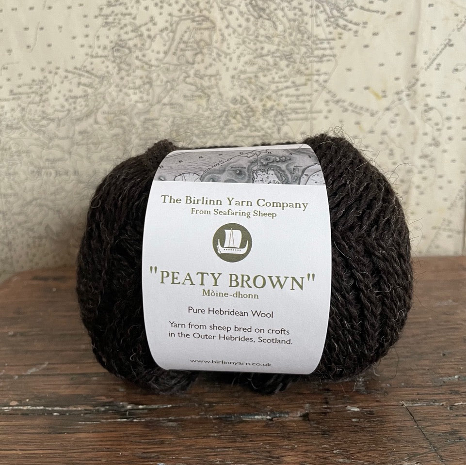 Ball of 4 ply finger weight un-dyed natural dark brown yarn from Hebridean sheep on Berneray. Scottish Textiles Showcase.