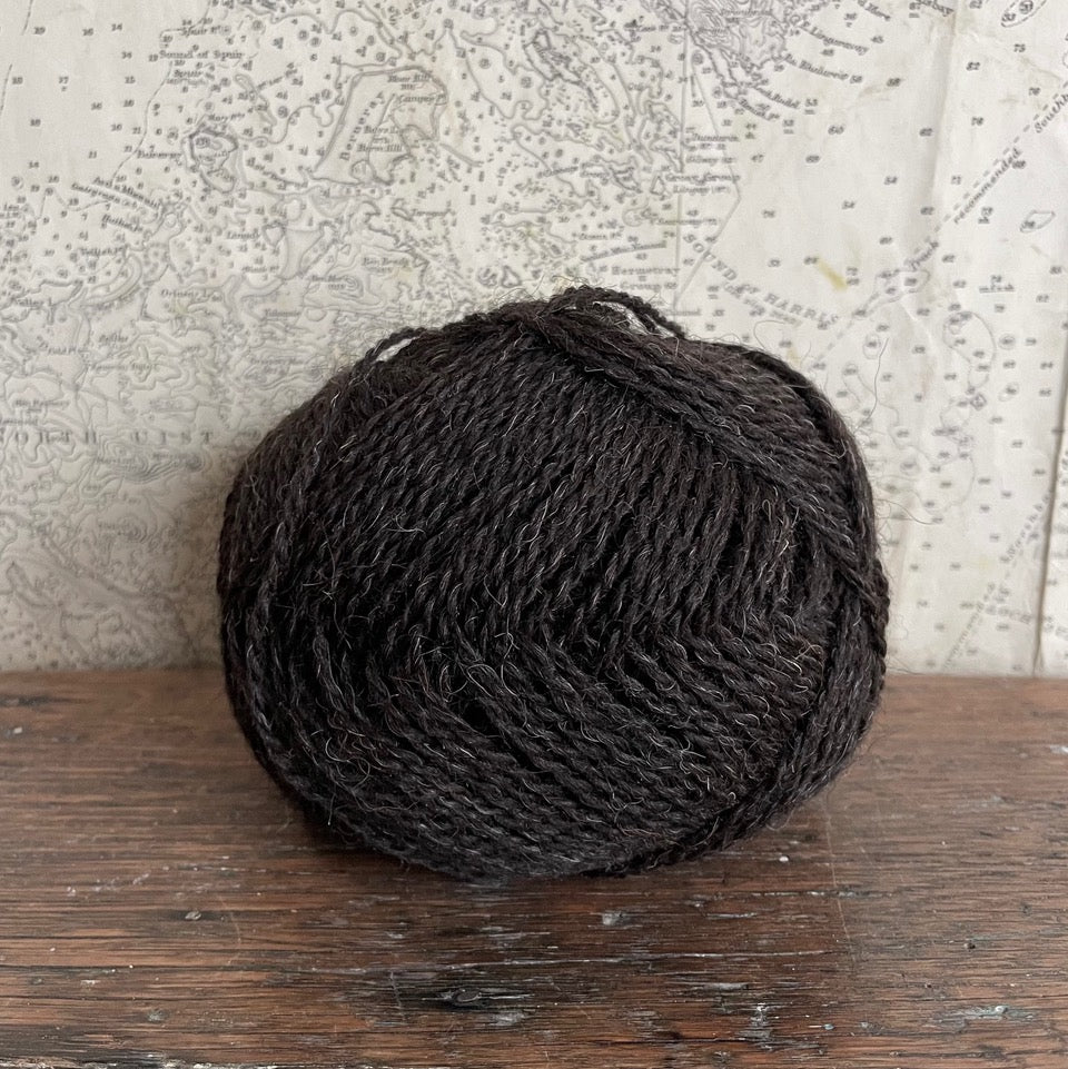 Ball of 4 ply finger weight un-dyed natural dark brown yarn from Hebridean sheep on Berneray. Scottish Textiles Showcase.