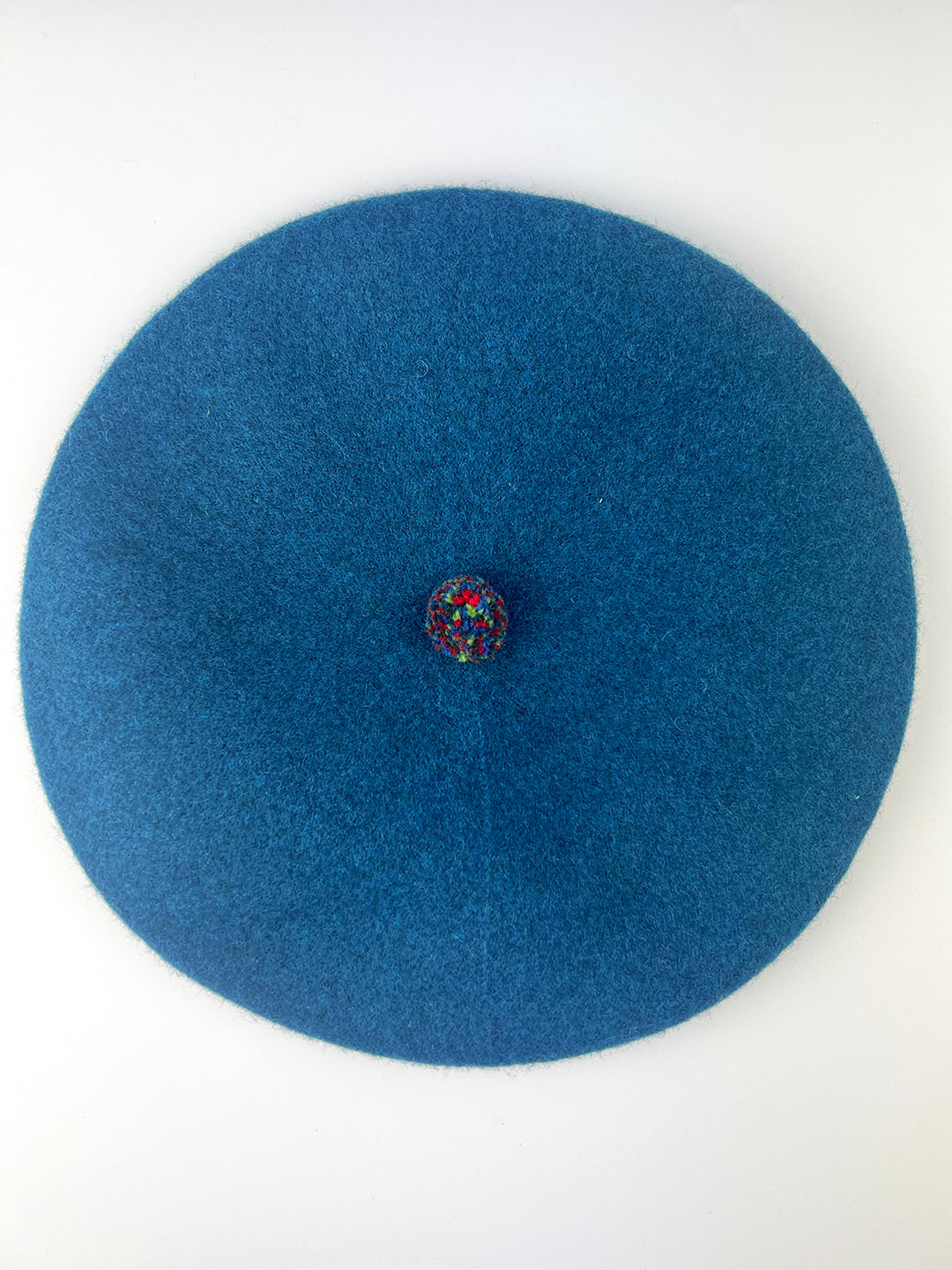 stylish bold berets with colourful pom pom detail in peacock blue, Knitted in Scotland.