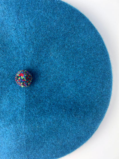 stylish bold berets with colourful pom pom detail in peacock blue, Knitted in Scotland.