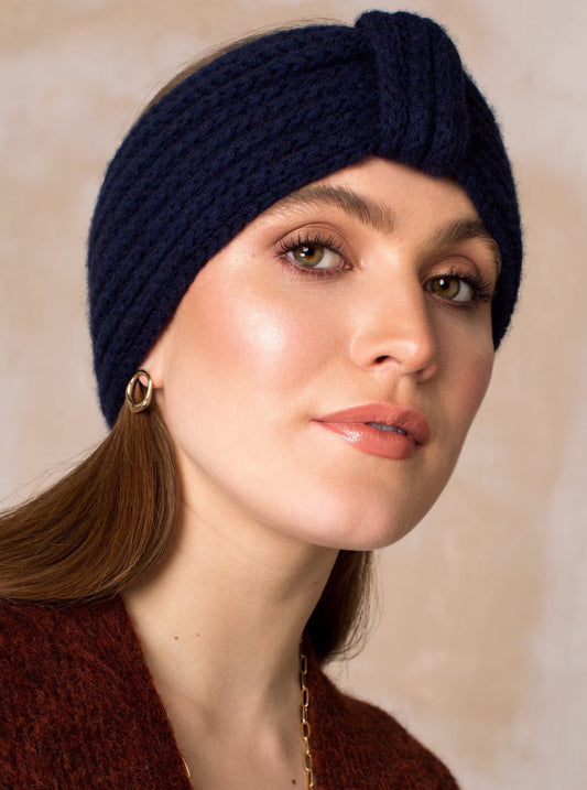 Model wearing cashmere headband in shade blackberry