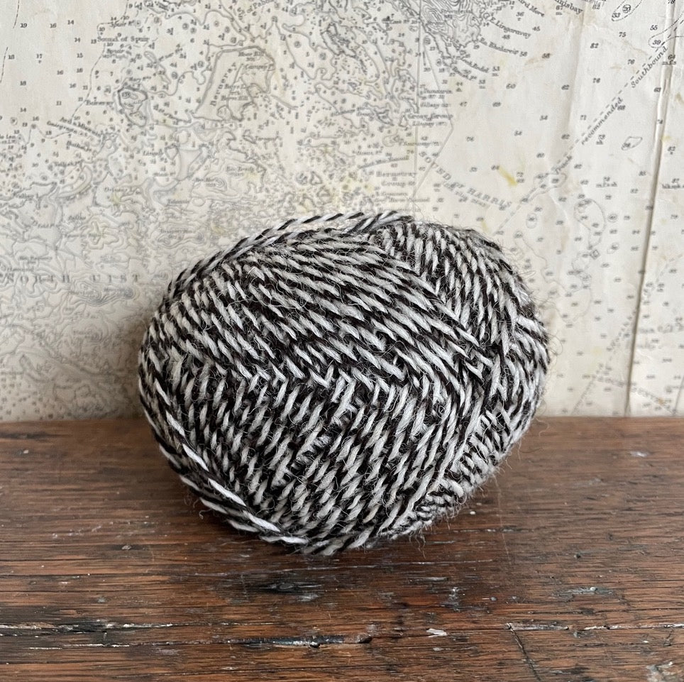 Ball of 4 ply finger weight un-dyed natural yarn from a blend of Hebridean and Cheviot sheep on Berneray. Scottish Textiles Showcase.
