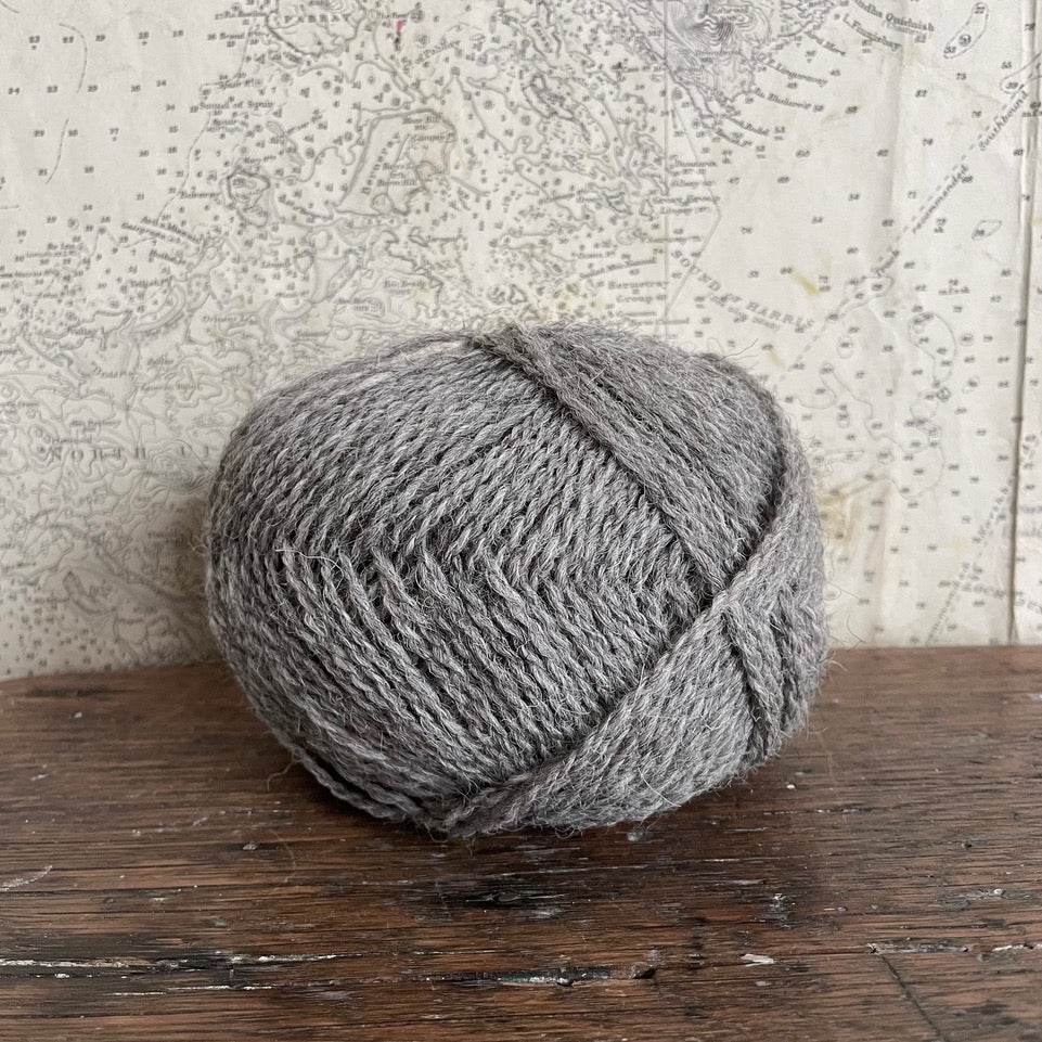 Ball of 4 ply finger weight un-dyed natural yarn from a blend of Hebridean and Cheviot sheep on Berneray. Scottish Textiles Showcase.
