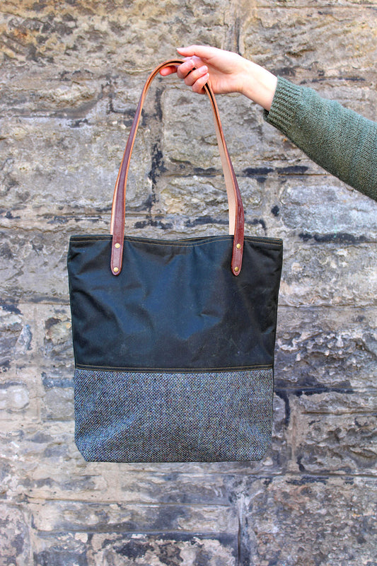 Scottish Textiles Showcase and Fernweh tote bag collaboration in waxed cotton and Harris Tweed. Earth brown and green with brown leather straps.