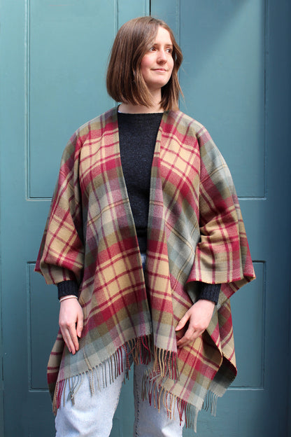 The Auld Scotland tartan serape features earthy shades of green, burgundy, camel and dusky blue.