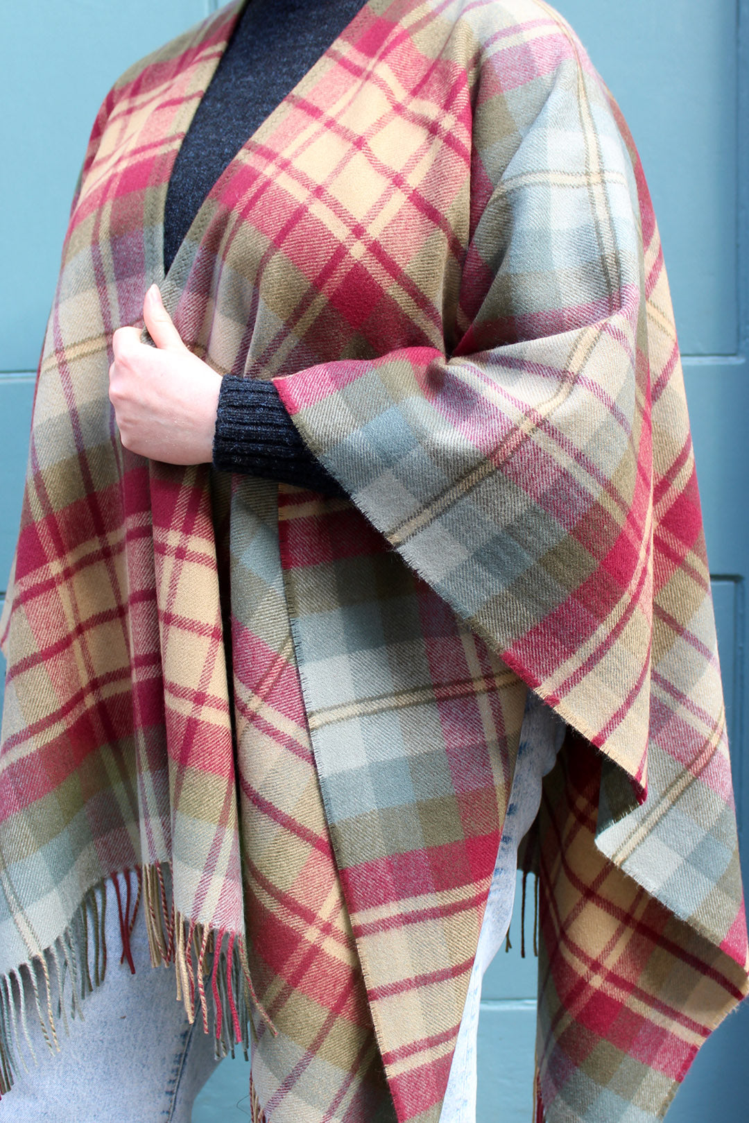 The Auld Scotland tartan serape features earthy shades of green, burgundy, camel and dusky blue.