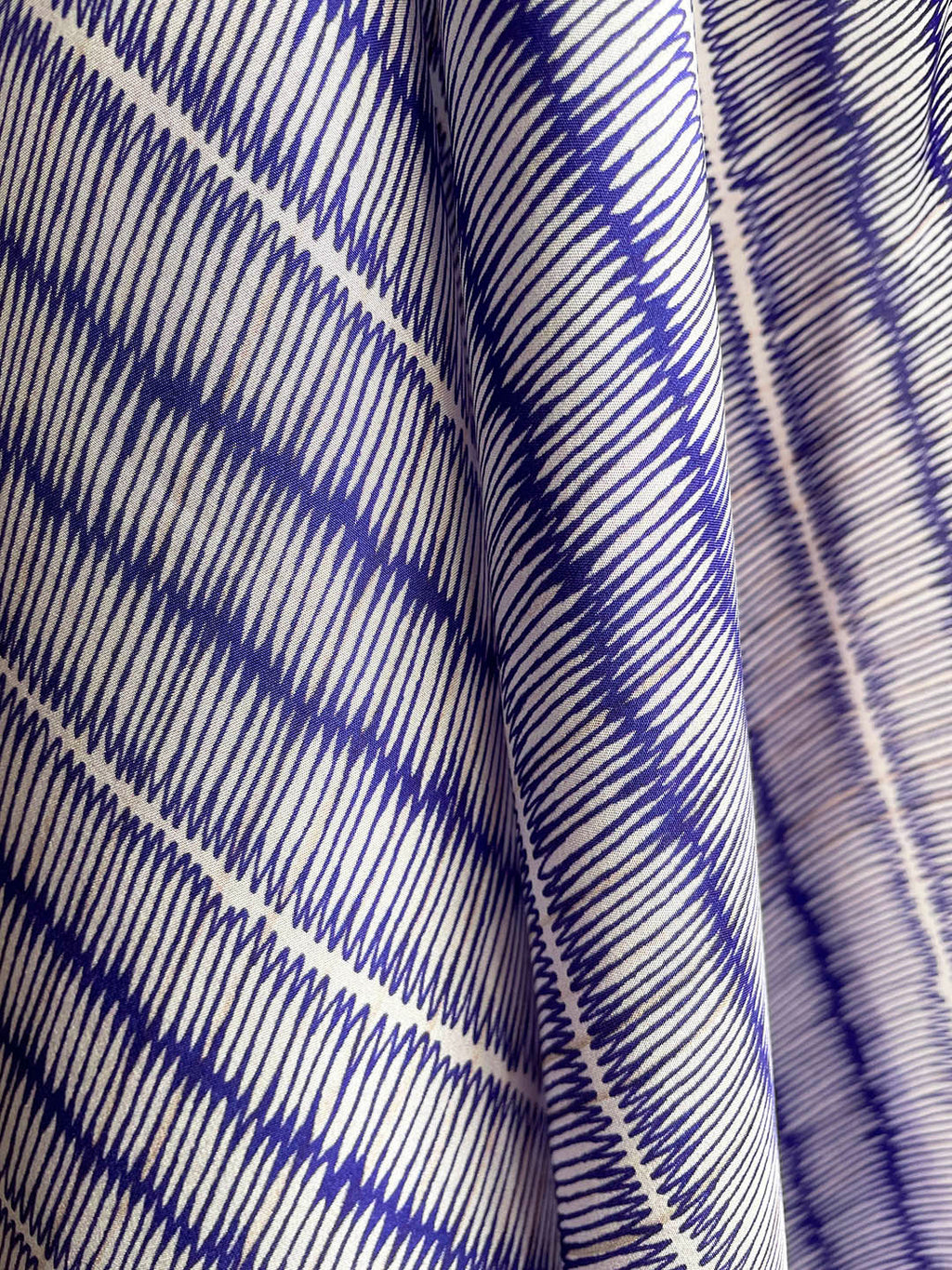 Blue and ivory large silk scarf with intricate hand-drawn print, shown close-up with details.