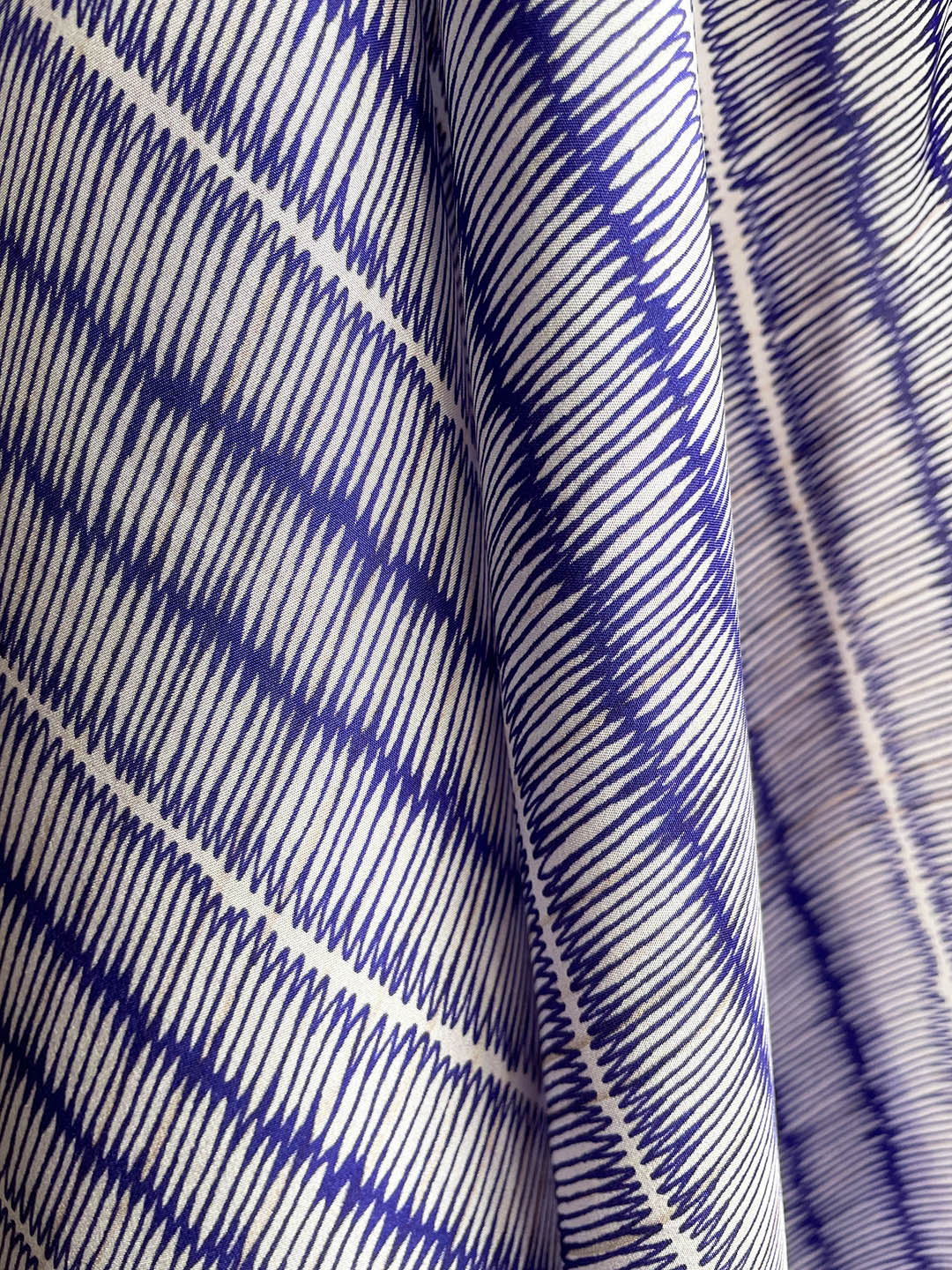 Blue and ivory large silk scarf with intricate hand-drawn print, shown close-up with details.