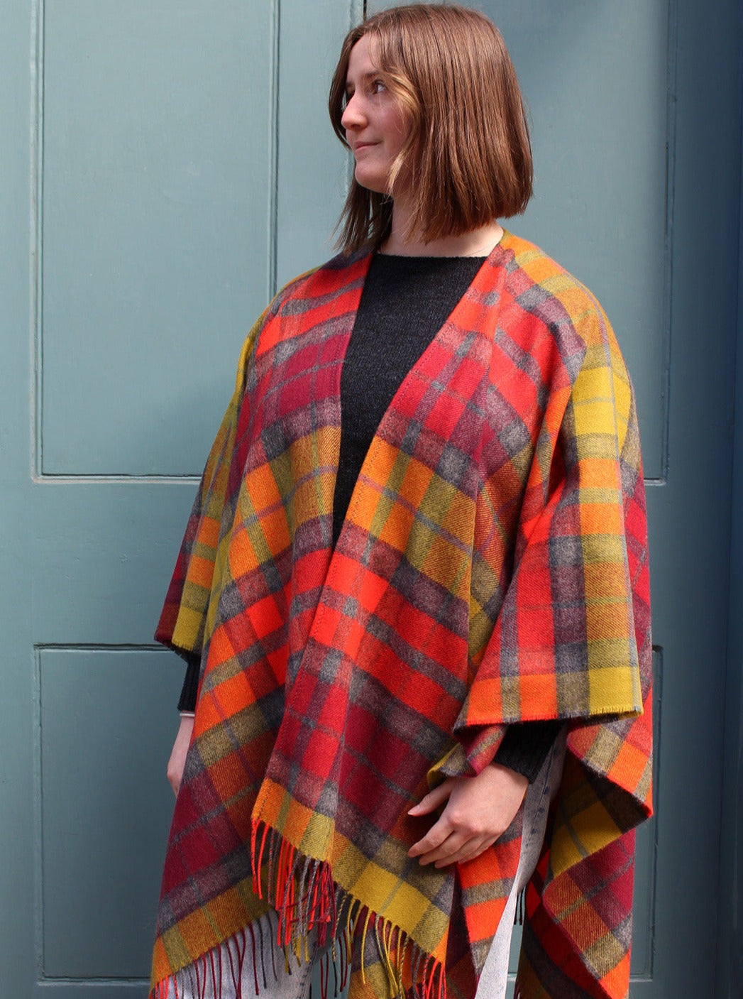 The Buchanan Berry tartan serape features a bold check in an eye catching combination of red, orange, chartreuse and grey.