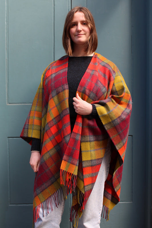 The Buchanan Berry tartan serape features a bold check in an eye catching combination of red, orange, chartreuse and grey.