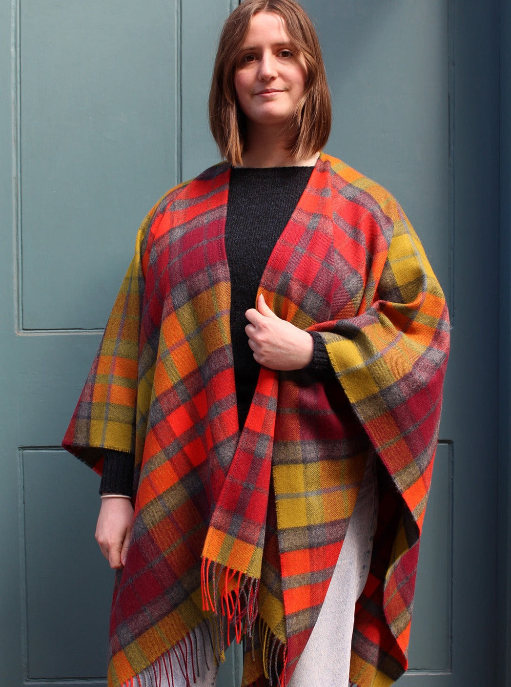 The Buchanan Berry tartan serape features a bold check in an eye catching combination of red, orange, chartreuse and grey.