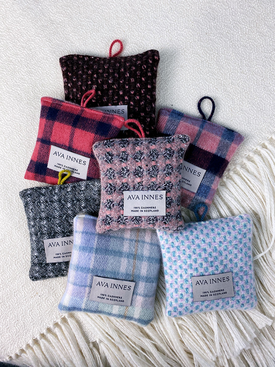 Sustainable hanging lavender bags in a range of pure cashmere check pattern designs. Colours include soft blue, lilac, purple, pink and grey. Scottish Textiles Showcase.