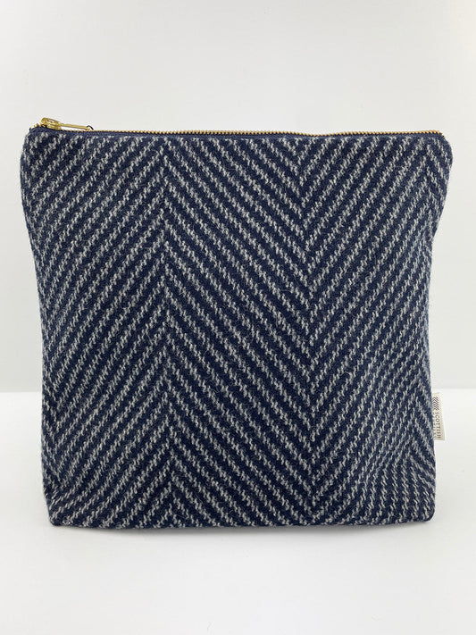 Navy and grey herringbone tweed zipped pouch bag.