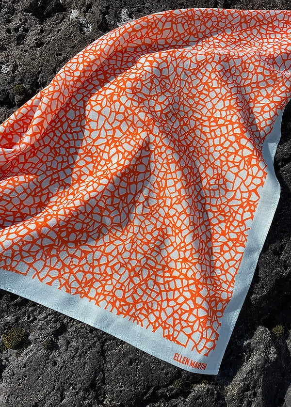 Wool and silk blend square scarf featuring intricate repeat pattern in pale blue and orange.
